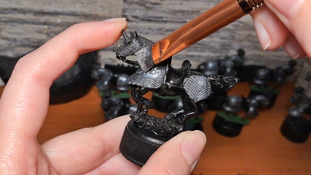 Wargaming painting drybrushing technique on a textured miniature surface
