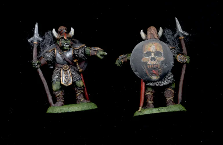 Collectors quality 25mm orc warrior miniature in horned helmet with detailed freehand skull painted on the shield.