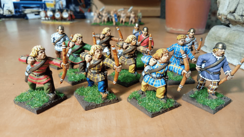 Historical archer miniatures on grass-covered bases for tabletop wargaming