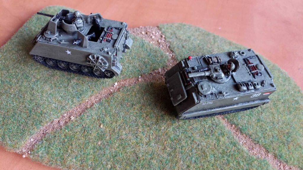 Two WWII tank miniatures mounted on a textured gaming base with earth effects