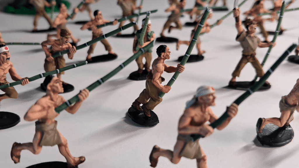 A unit of 28mm WWII Japanese miniatures with bamboo spears, showing slight skin tone variations and realistic shading across different models.