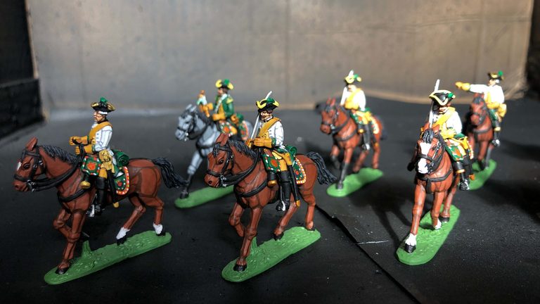 Group of painted Napoleonic cavalry horses in different brown coat colors