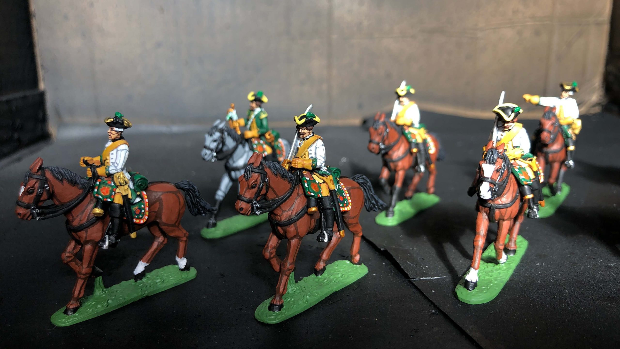 Group of painted Napoleonic cavalry horses in different brown coat colors